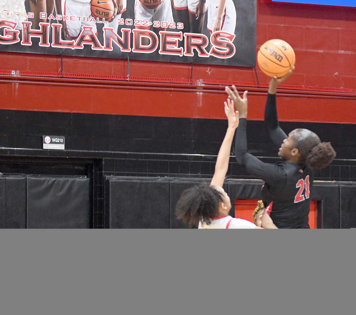 Colonial's Jasmynne George puts up a hook shot over Lake Highland Prep's Ari Woodard. George had 10 points and a game-high 11 rebounds for the Grenadiers.